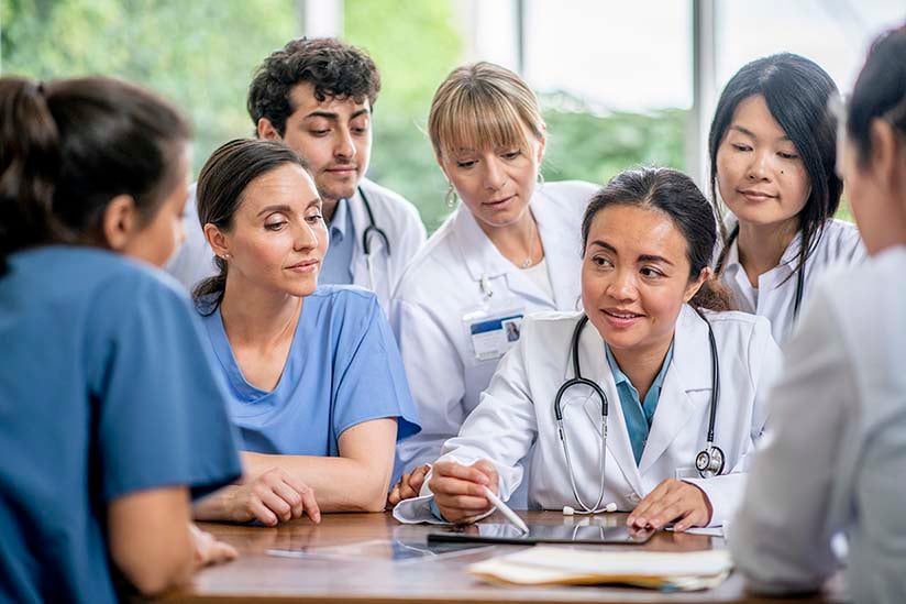 A medical professional explaining something to her team.