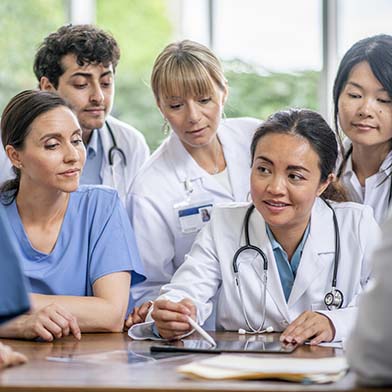 A medical professional explaining something to her team.