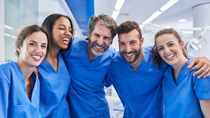 Group of nurses stood together and smiling